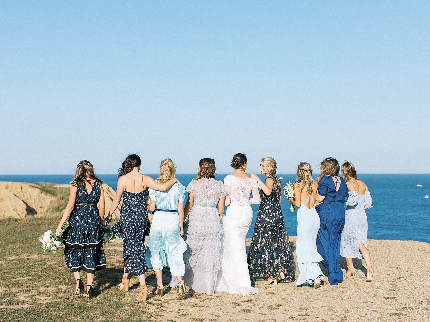 bridesmaids pose on beach with Asher Gardner Photography