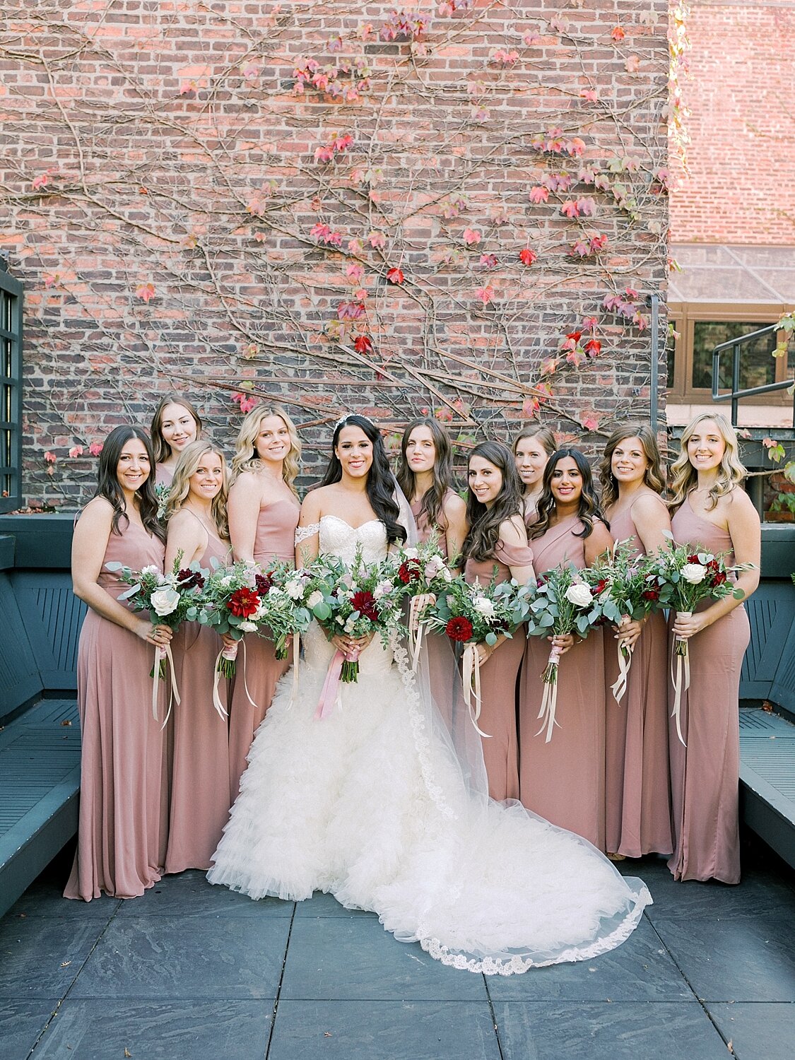 bridesmaids pose for Asher Gardner Photography on the rooftop of the Foundry