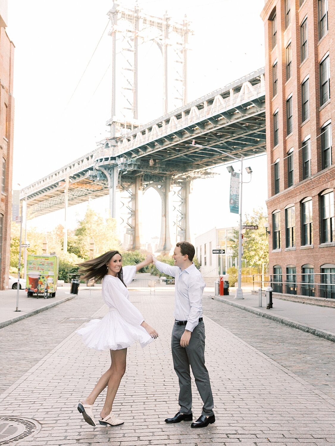 couple dances in front of Brooklyn Bridge with Asher Gardner Photography