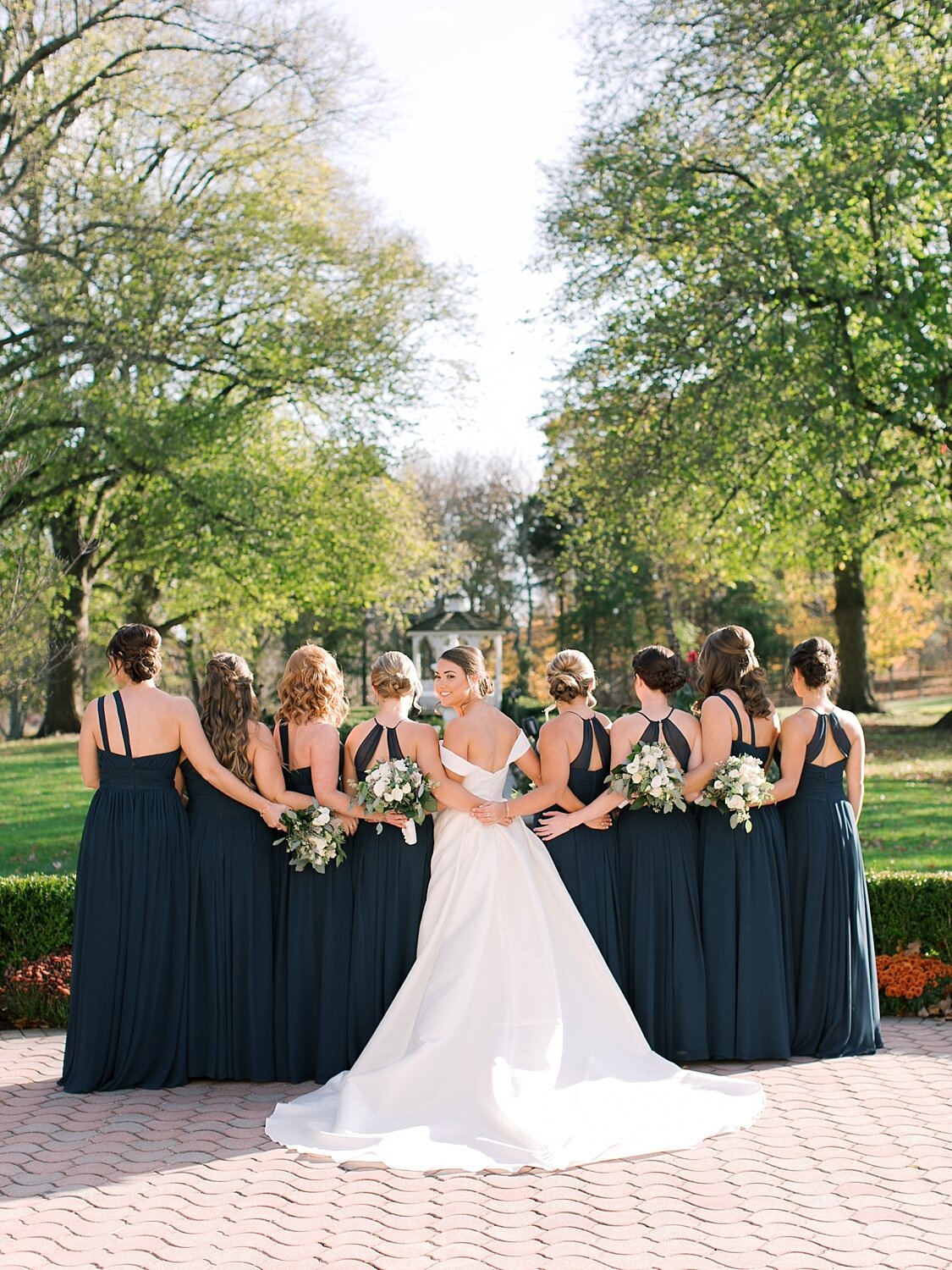 bridesmaids and bride pose for Asher Gardner Photography at the Mansion at Oyster Bay