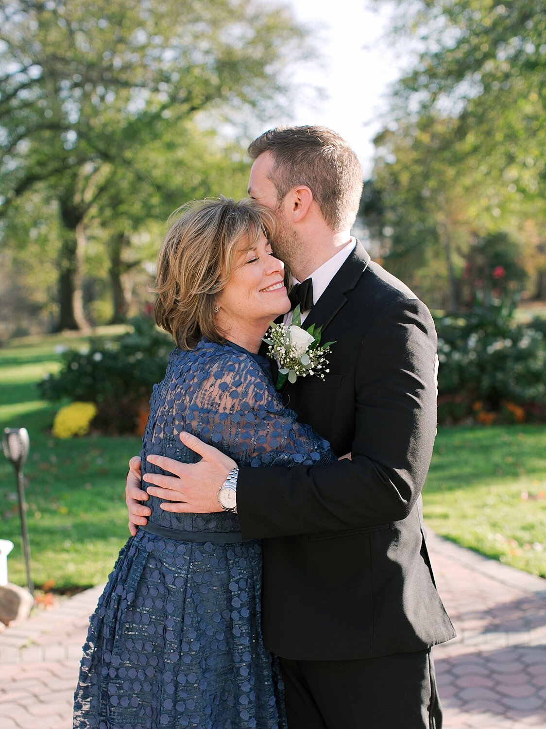 groom's mother hugs son with Asher Gardner Photography