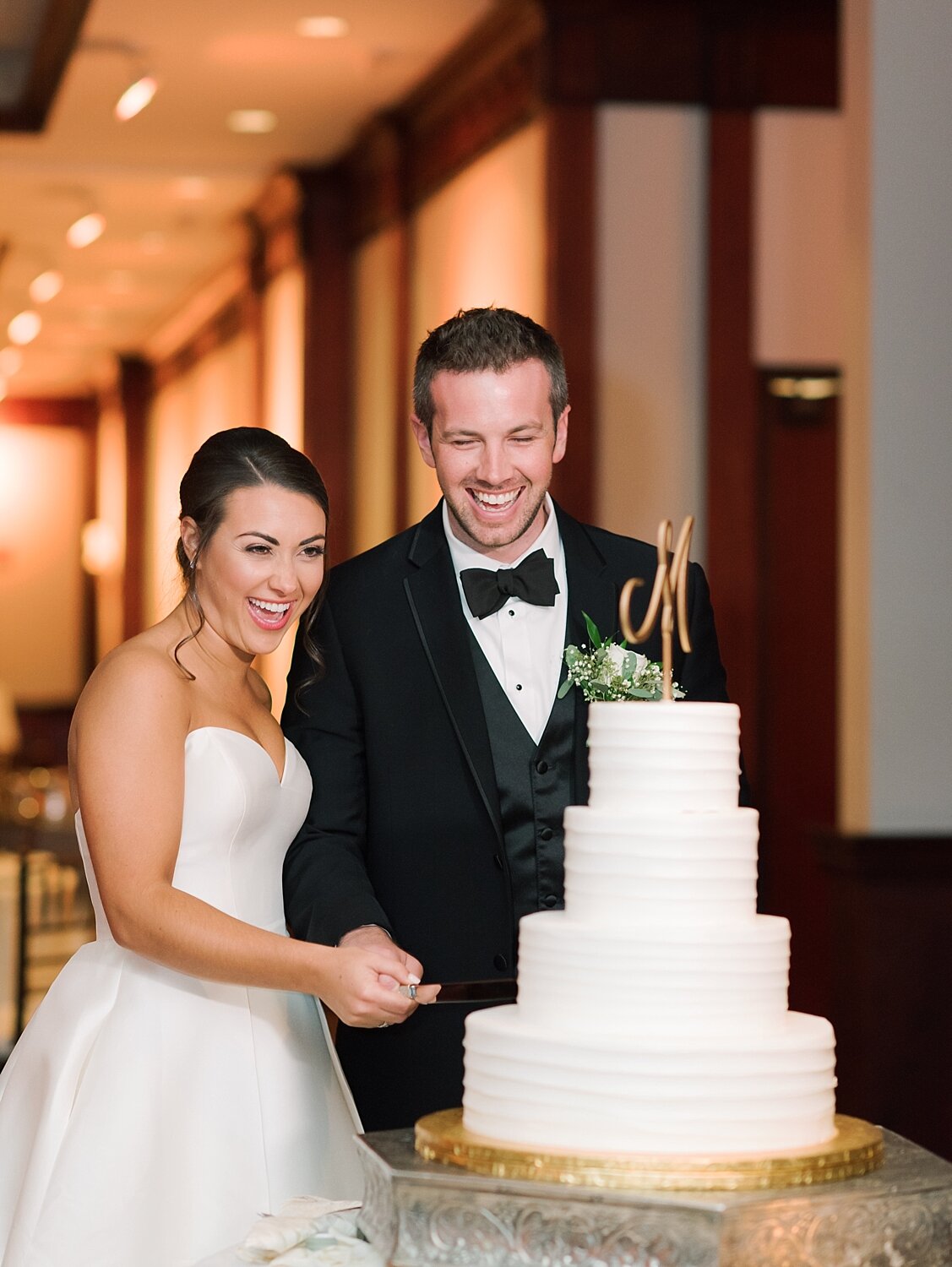 bride and groom cut cake from Dortoni Bakery photographed by Asher Gardner Photography