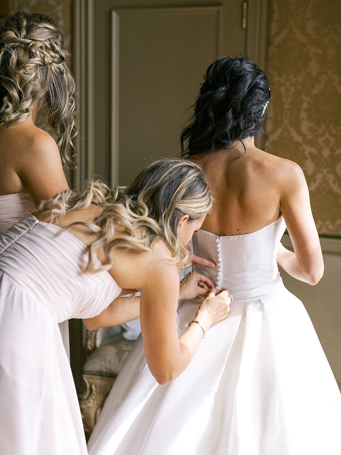bride gets into wedding dress photographed by Asher Gardner Photography