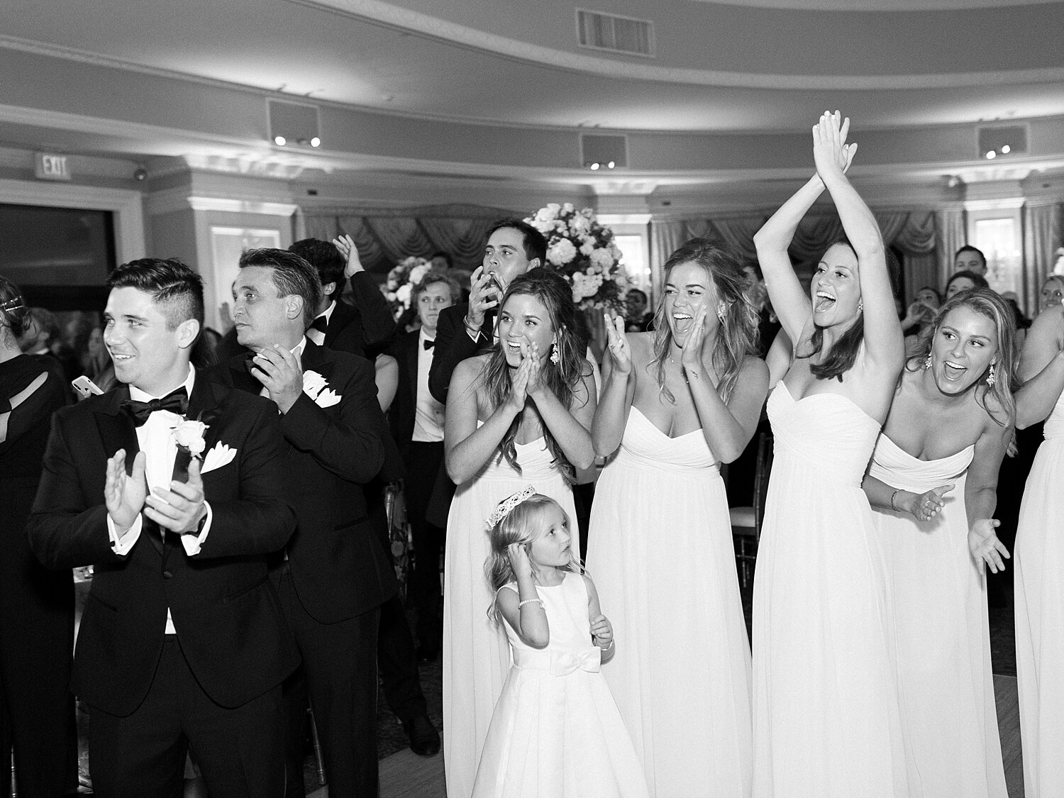 bridal party welcomes newlyweds to Oheka Castle wedding reception photographed by Asher Gardner Photography