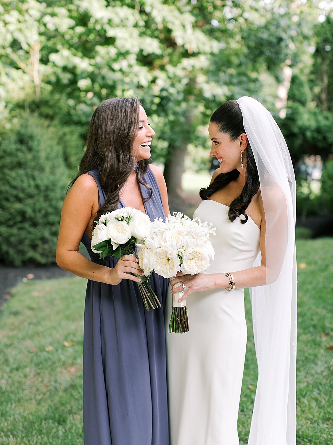 bridesmaid laughs with bride during NY wedding | Stylish Private Home Wedding Inspiration | Asher Gardner Photography
