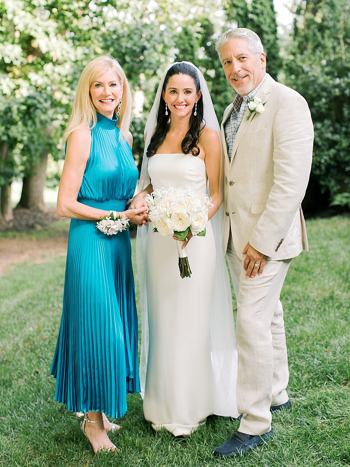 bride poses with family in New York yard | Stylish Private Home Wedding Inspiration | Asher Gardner Photography