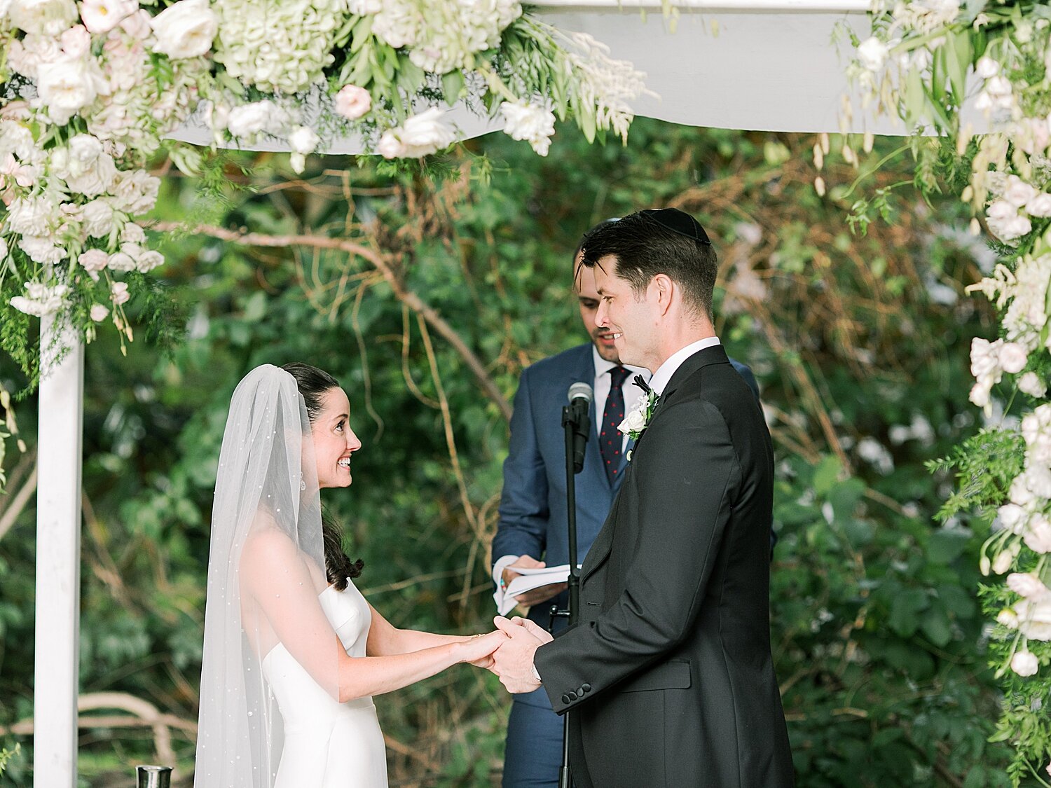 bride and groom exchange vows during wedding ceremony at home | Stylish Private Home Wedding Inspiration | Asher Gardner Photography