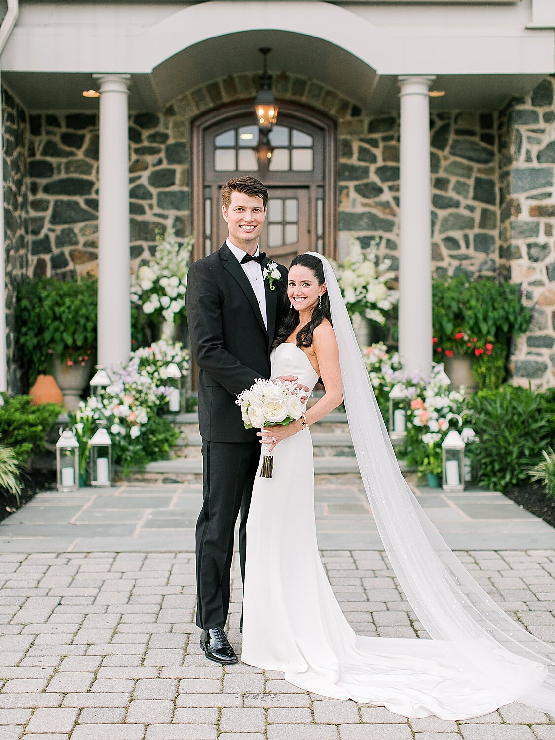 bride and groom stand in front of home | Stylish Private Home Wedding Inspiration | Asher Gardner Photography