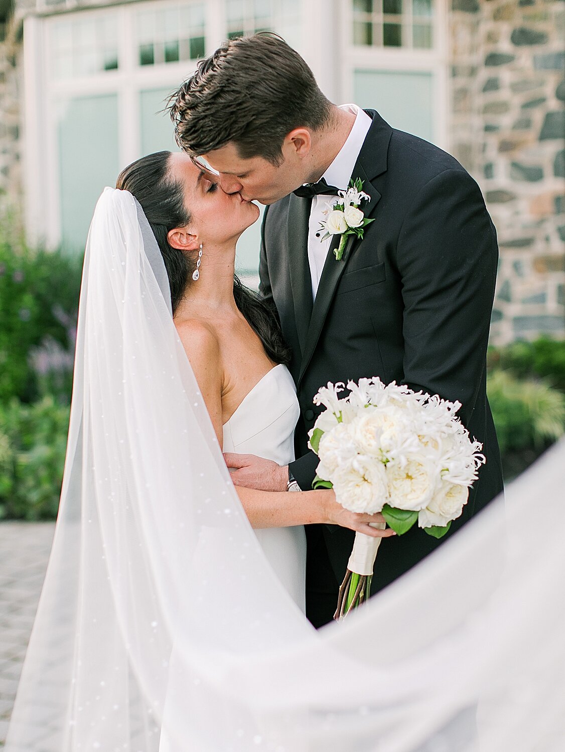 bride and groom kiss with veil wrapped around them | Stylish Private Home Wedding Inspiration | Asher Gardner Photography