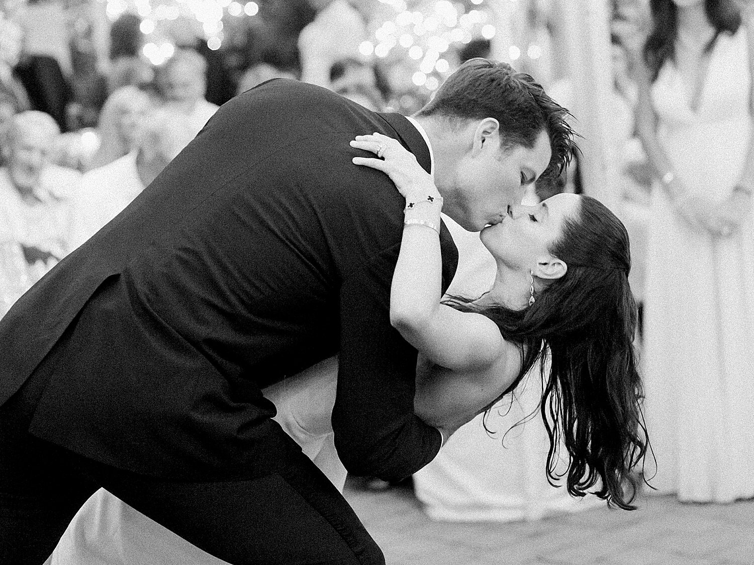 groom dips bride and kisses her during wedding reception | Stylish Private Home Wedding Inspiration | Asher Gardner Photography