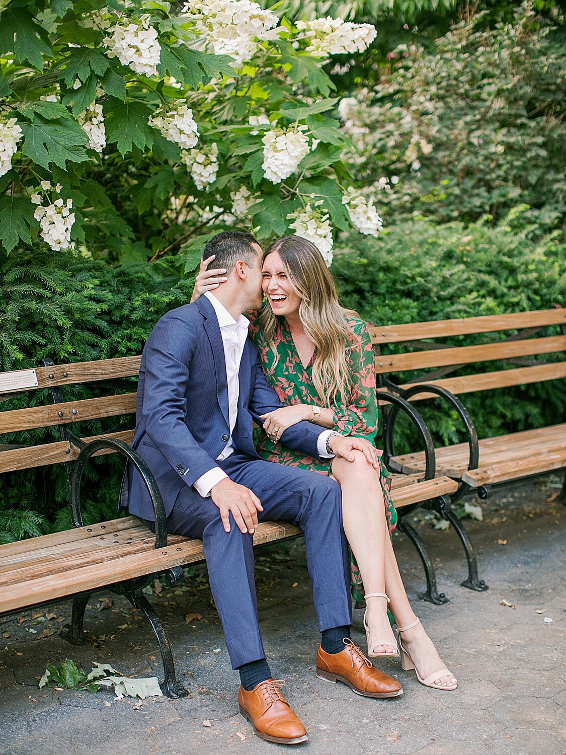 couple laughs and snuggles on park bench in NYC | Asher Gardner Photography | The Village engagement session