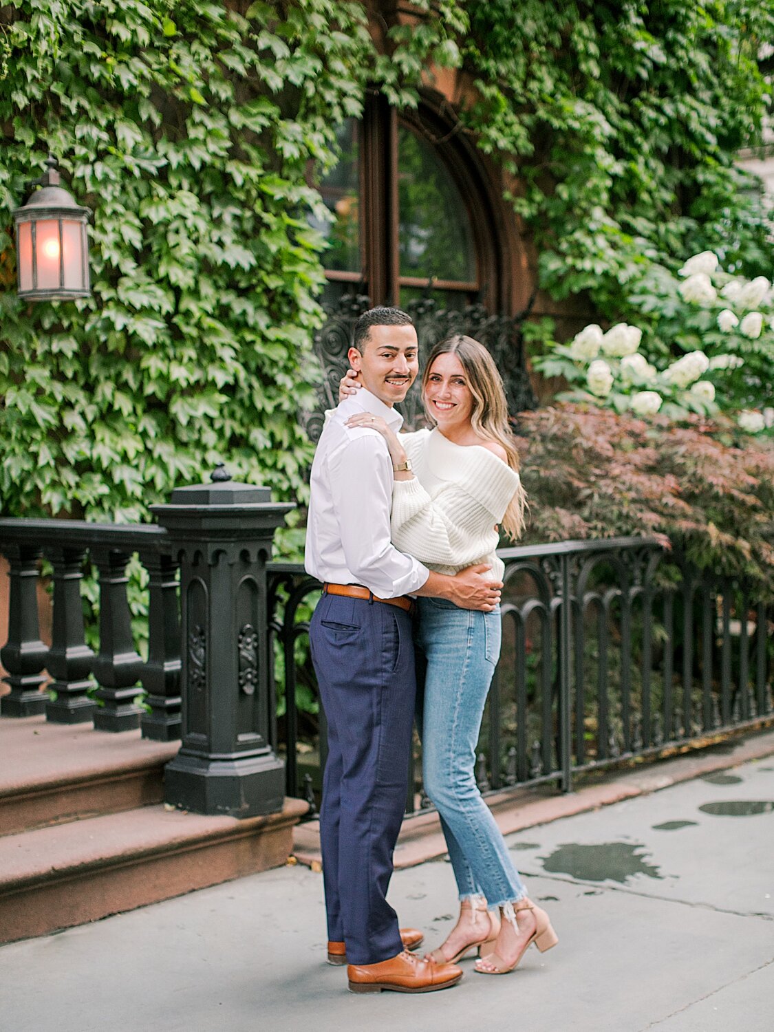 engaged couple poses by ivy wall  | Asher Gardner Photography | The Village engagement session