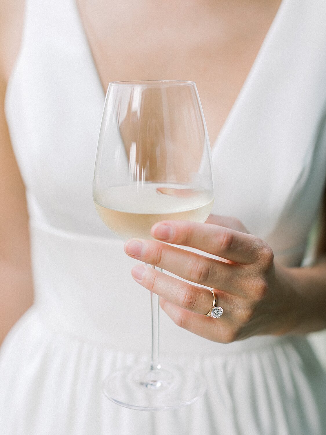 bride holds wine glass during wedding reception | Asher Gardner Photography | Intimate Ceremony in DUMBO New York