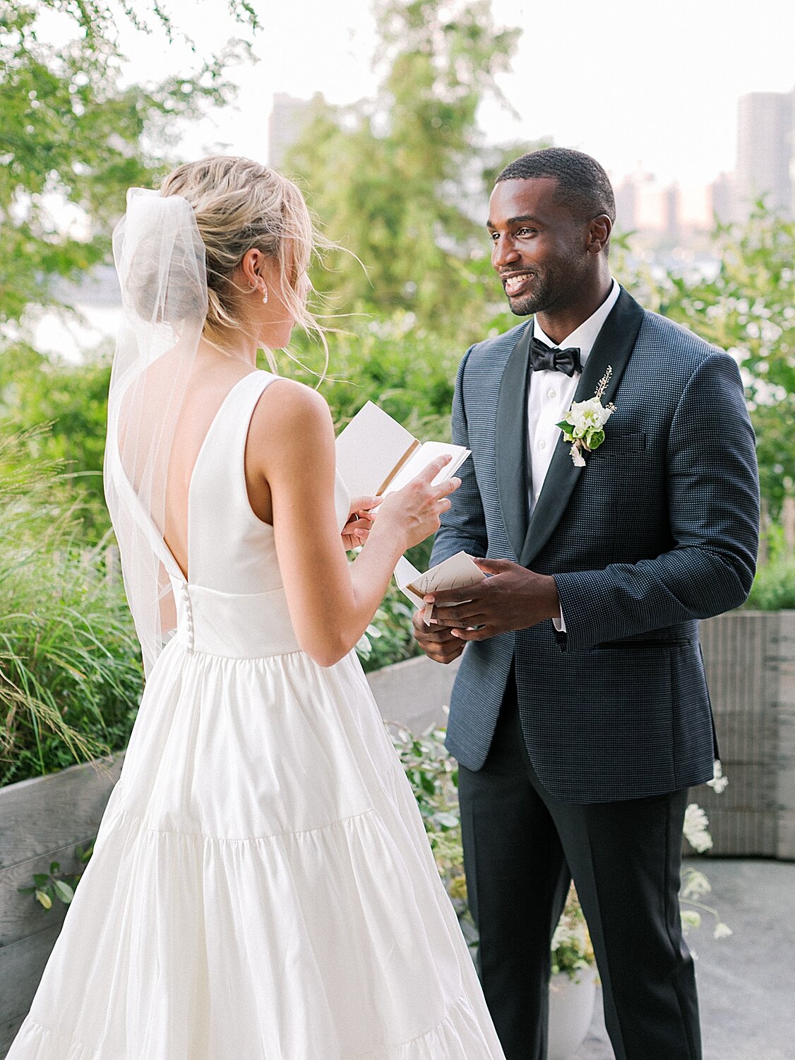 bride and groom read vows during wedding ceremony | Asher Gardner Photography | Intimate Ceremony in DUMBO New York