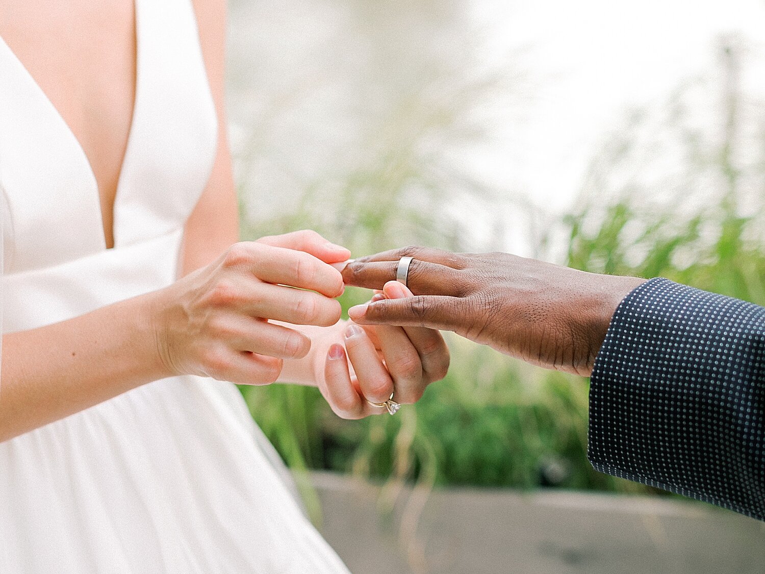 bride and groom exchange rings during intimate wedding ceremony at Celestine | Asher Gardner Photography | Intimate Ceremony in DUMBO New York