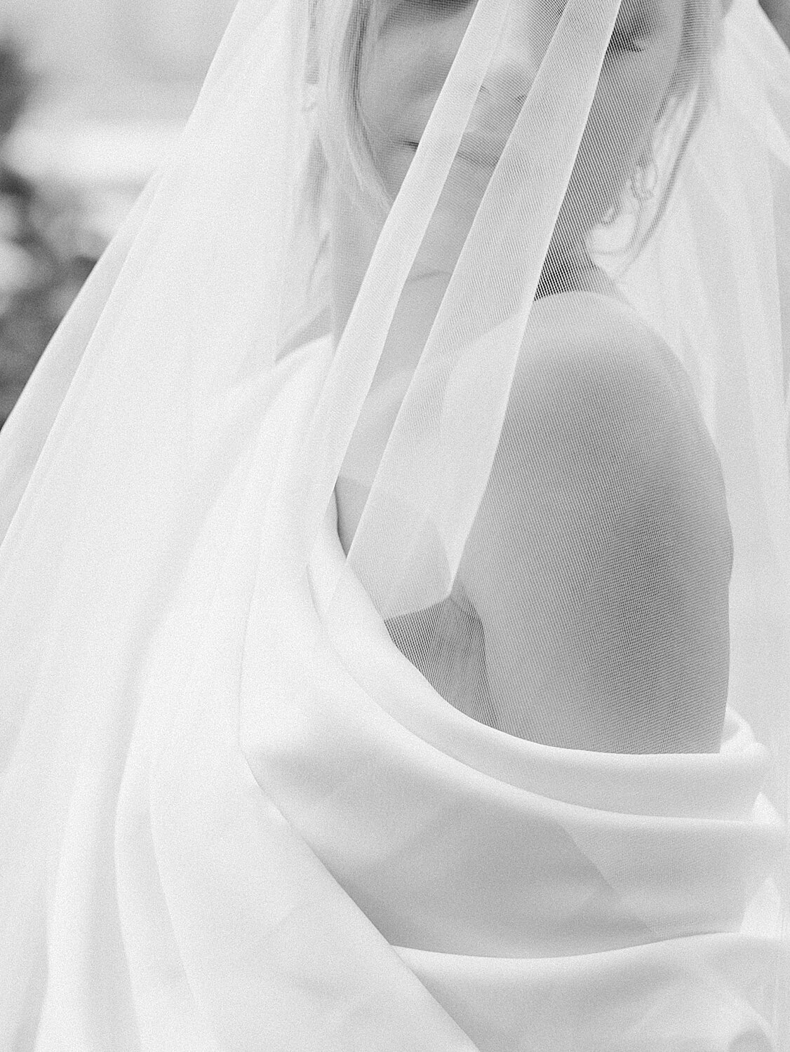 bride poses with veil around shoulders | Asher Gardner Photography | Intimate Ceremony in DUMBO New York