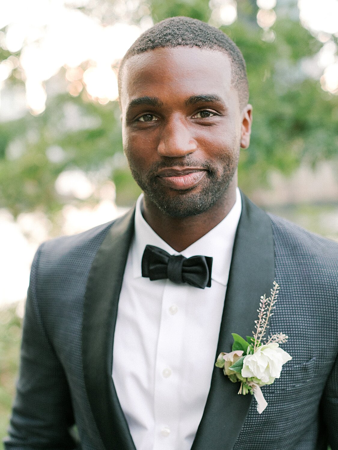 groom in classic black tux poses before Celestine wedding | Asher Gardner Photography | Intimate Ceremony in DUMBO New York