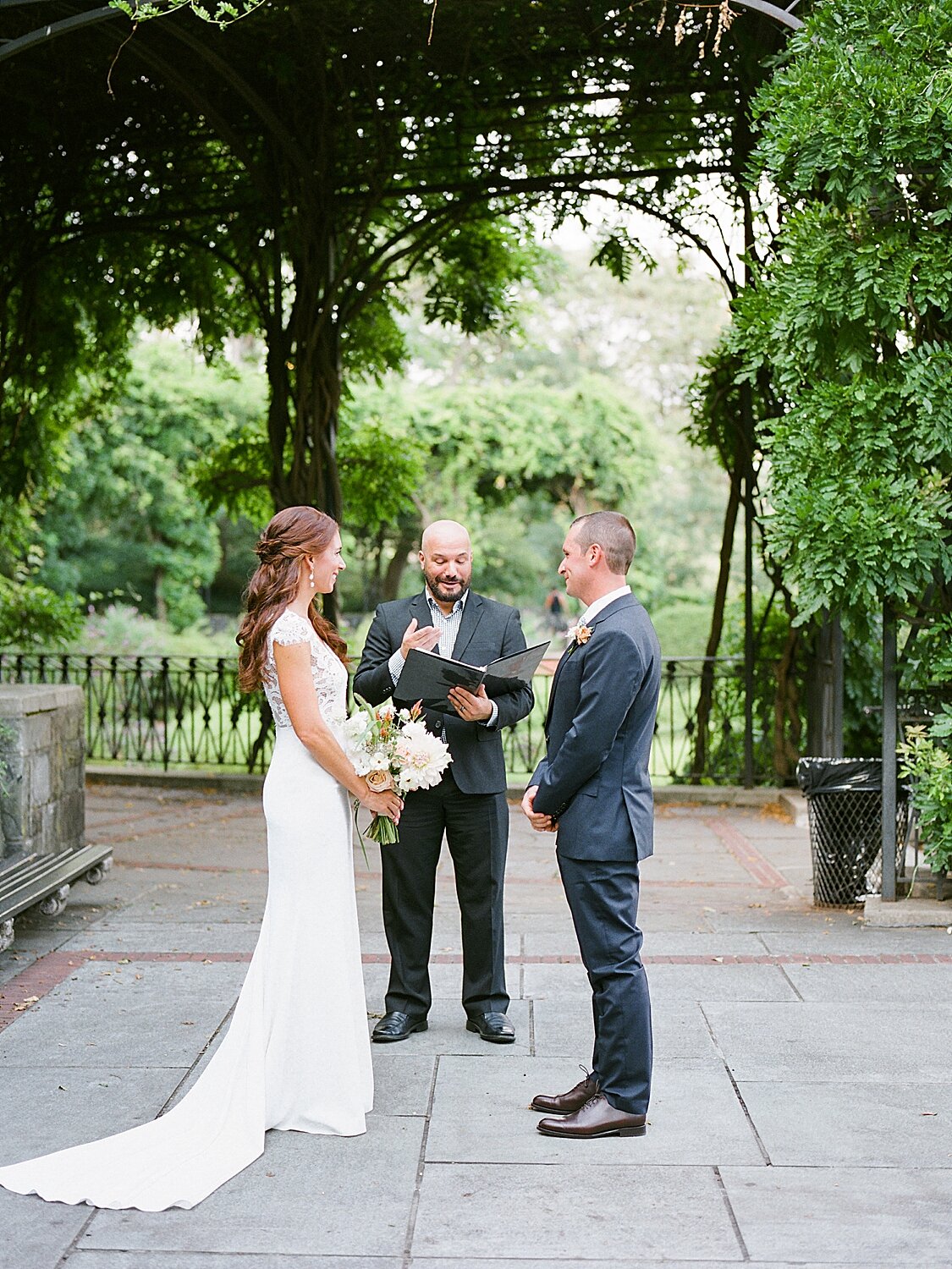 bride and groom exchange vows with officiant | Asher Gardner Photography | Elopement at the Central Park Conservatory Gardens