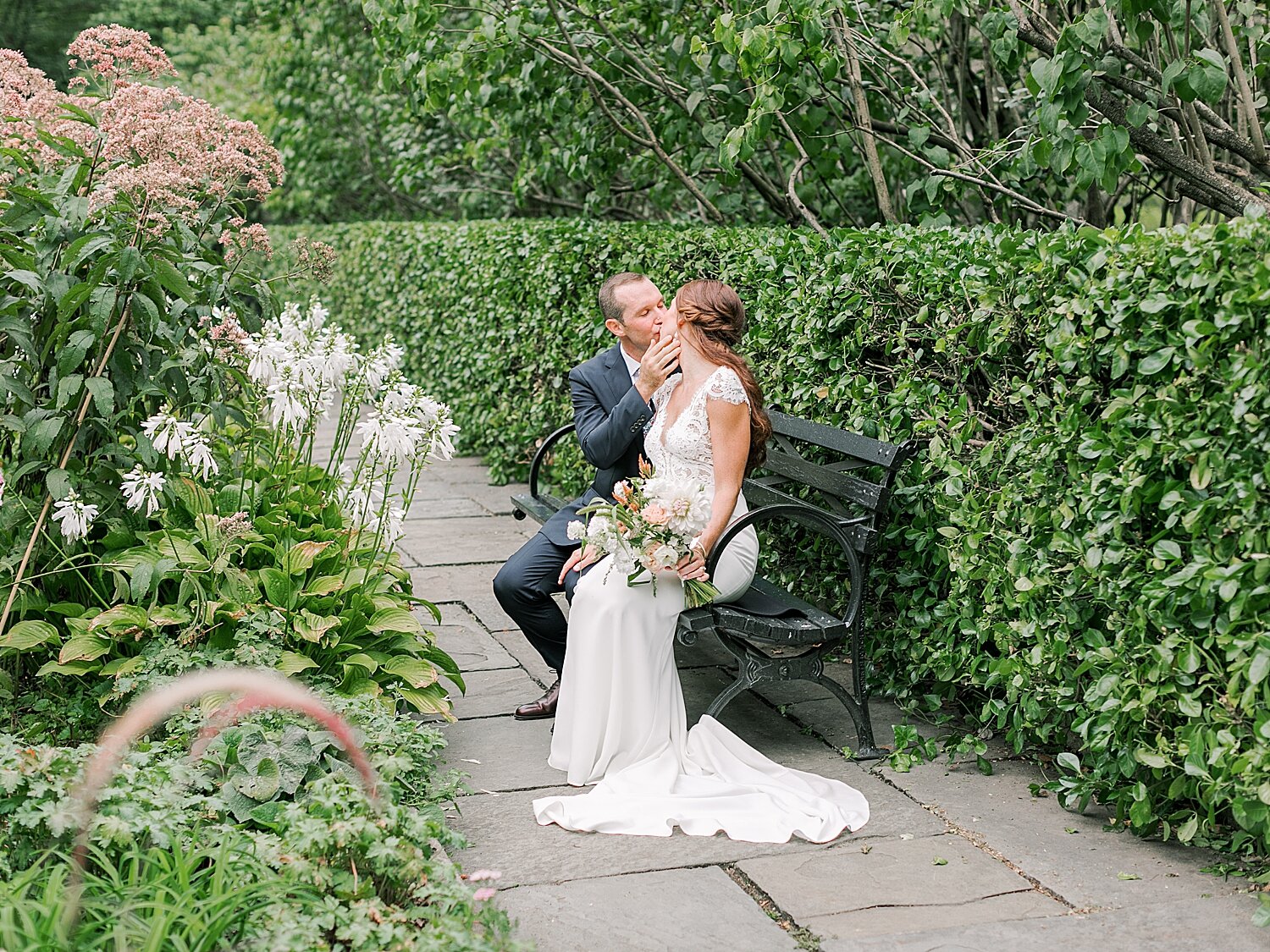 newlyweds kiss on bench in NYC | Asher Gardner Photography | Elopement at the Central Park Conservatory Gardens