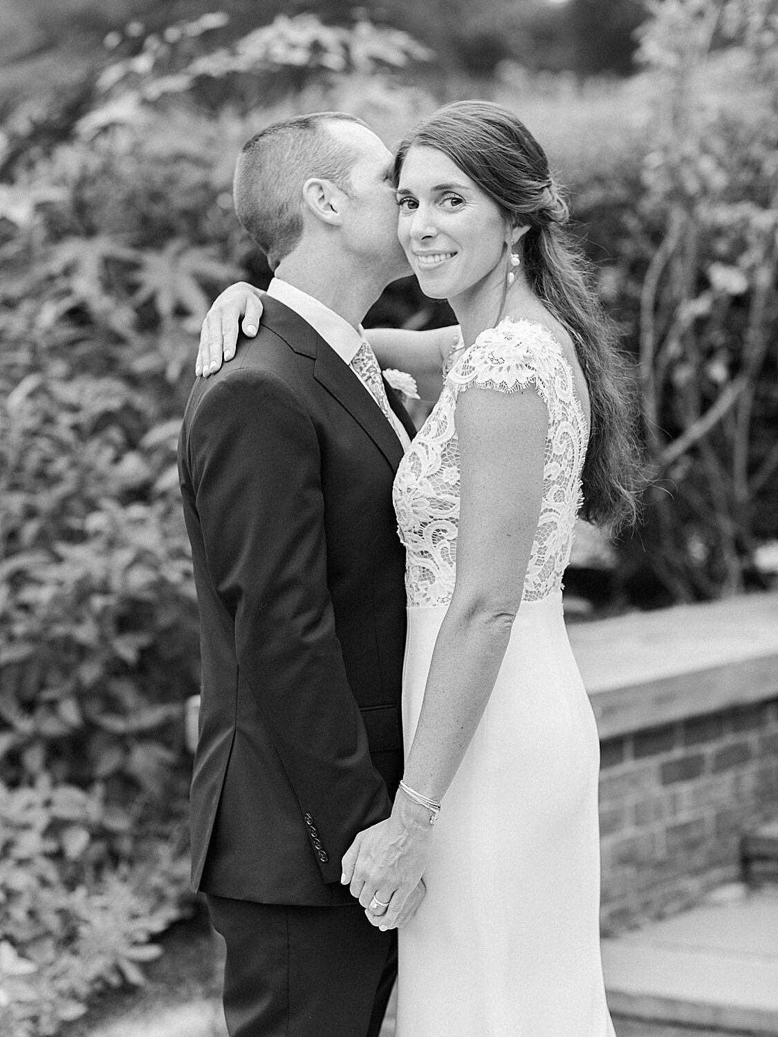 groom kisses bride's cheek during NYC wedding | Asher Gardner Photography | Elopement at the Central Park Conservatory Gardens