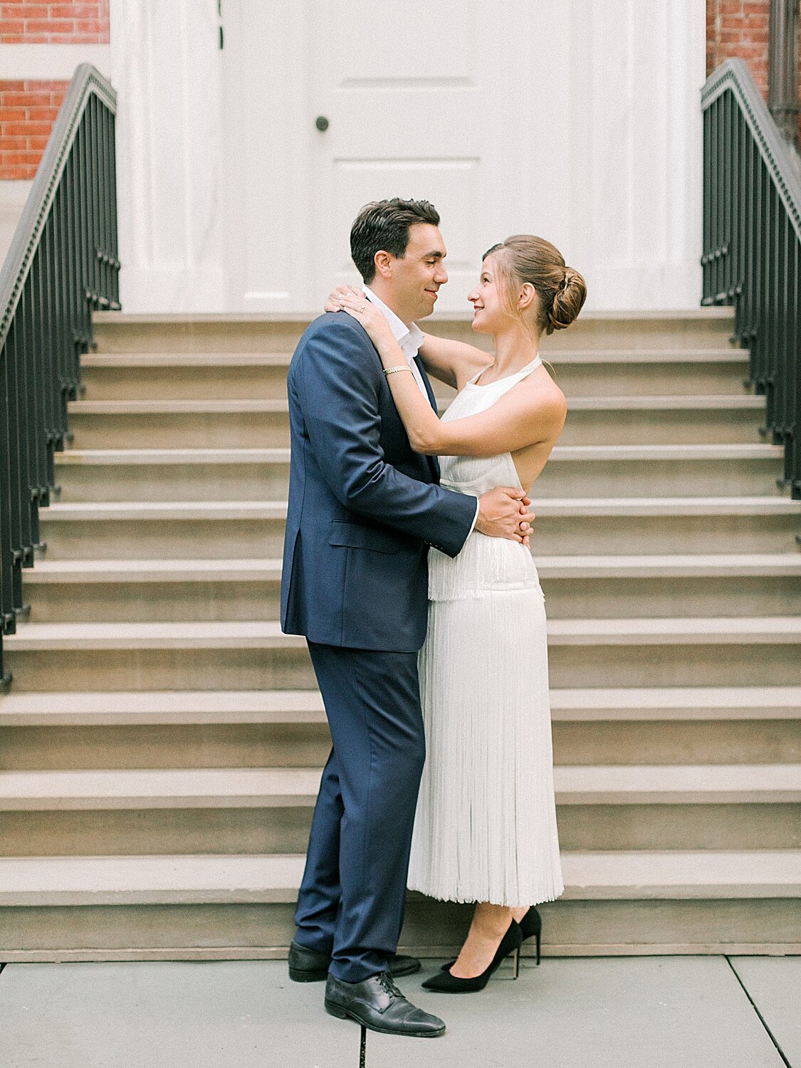 engaged couple poses by steps outside NYC home | Asher Gardner Photography | Gramercy Park Engagement Session
