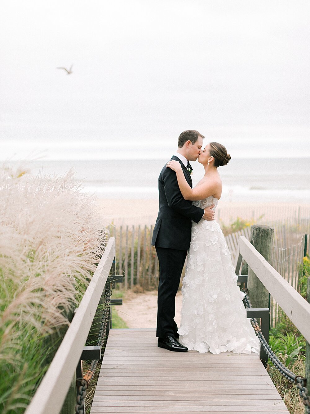 newlyweds kiss at Gurney’s Montauk Resort | Asher Gardner Photography shares top Tri-State Area wedding venues