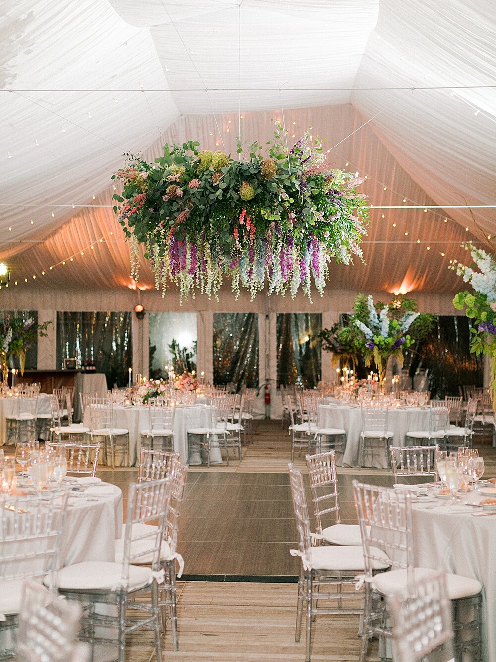 tented wedding reception with floral hanging | Tri-State Area Wedding Venues photographed by NY wedding photographer Asher Gardner Photography
