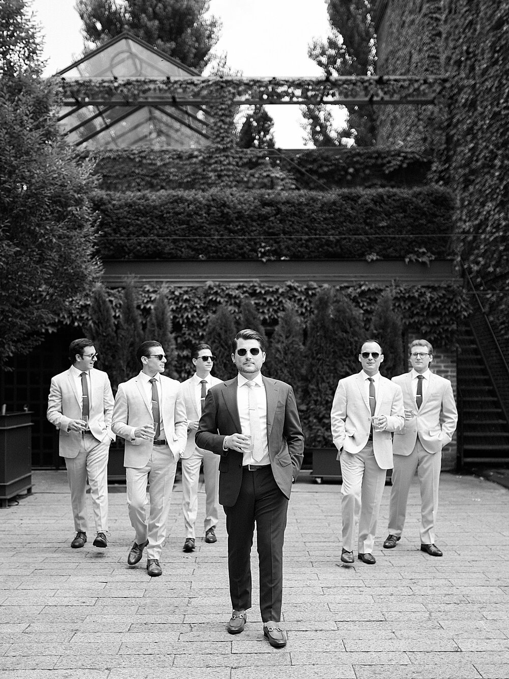 groomsmen walk around courtyard at the Foundry | Tri-State area wedding venues photographed by Asher Gardner Photography 
