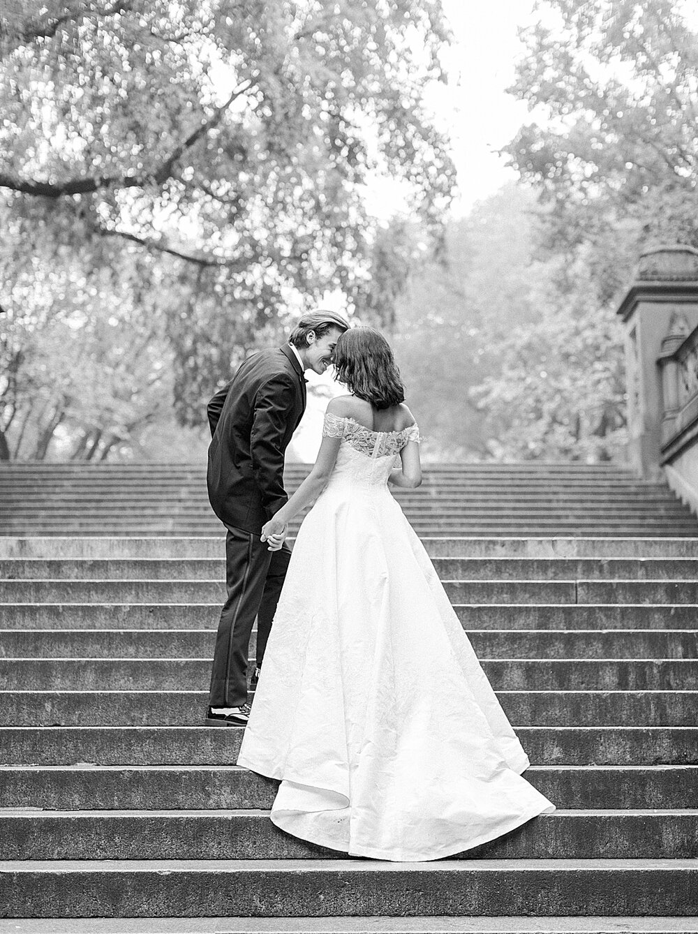 bride and groom pose on steps in Central Park | Tri-State area wedding venues photographed by Asher Gardner Photography