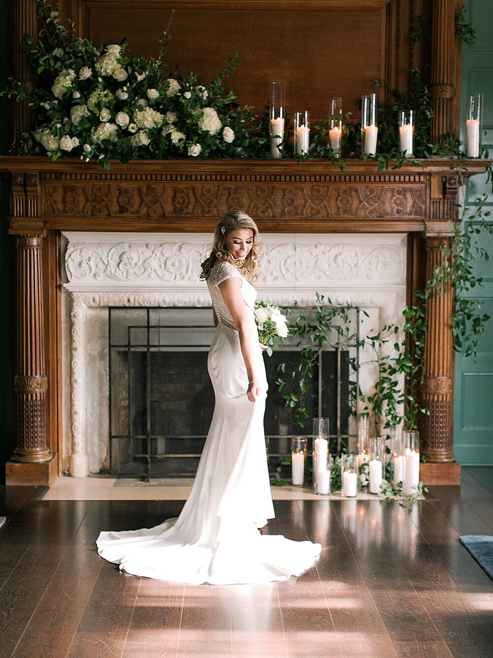 bridal portraits in front of historic fireplace lined with candles at Natirar Mansion | Tri-State area wedding venues photographed by Asher Gardner Photography