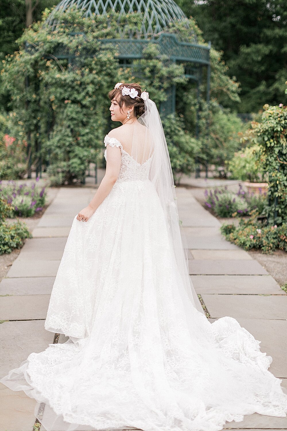 bride poses in gardens in the Bronx NY | Tri-State area wedding venues photographed by Asher Gardner Photography