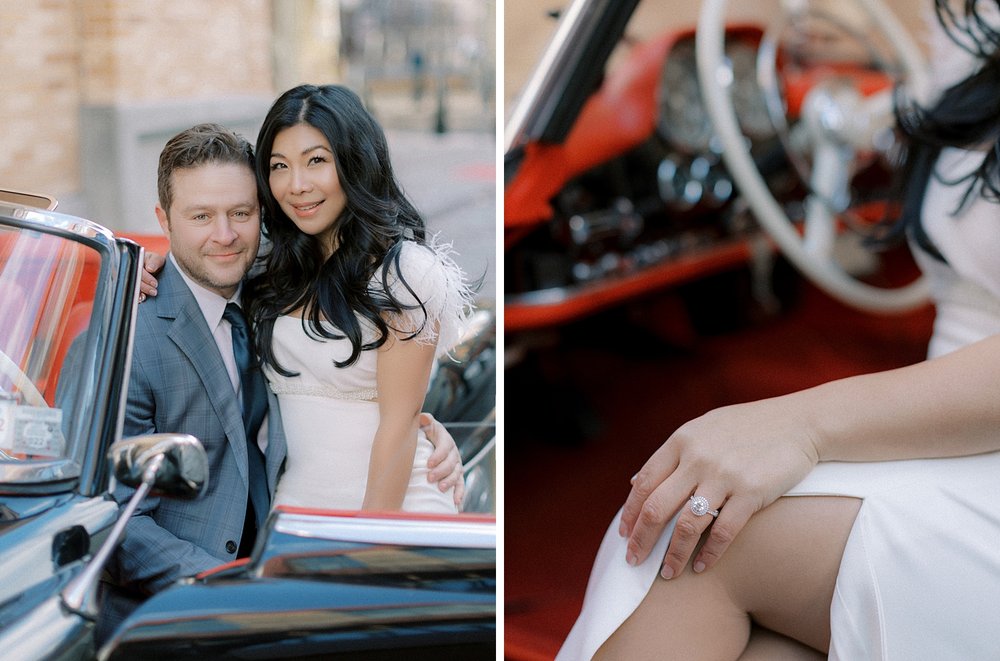 woman sits on man's lap inside classic Mercedes Benz 190sl and shows off engagement ring on knee