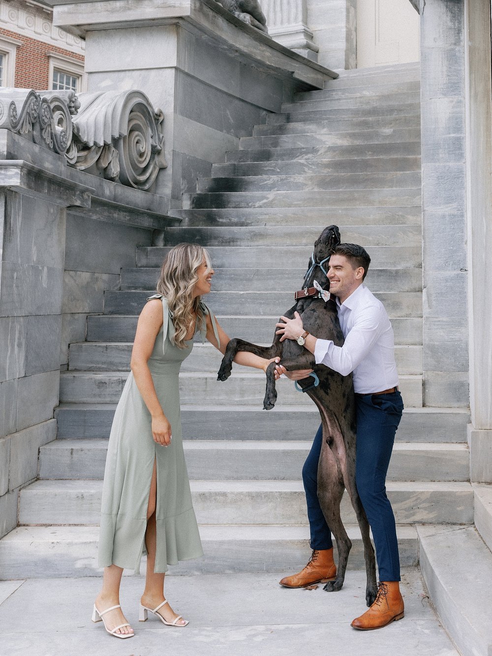 engaged couple laughs with Great Dane standing up between them in Philadelphia PA