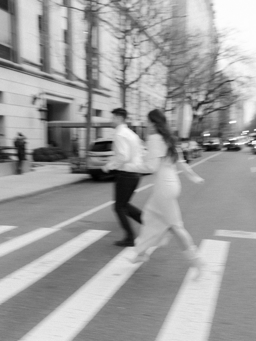 blurry photo of couple crossing crosswalk in the Upper East Side