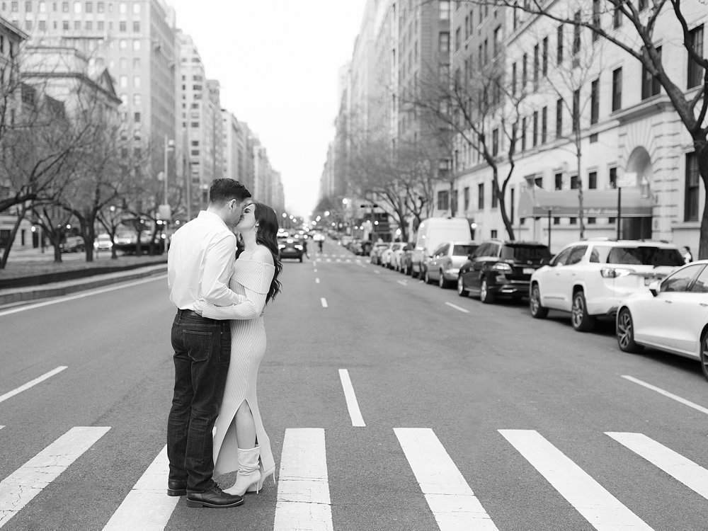 engaged couple hugs on cross walk in New York City