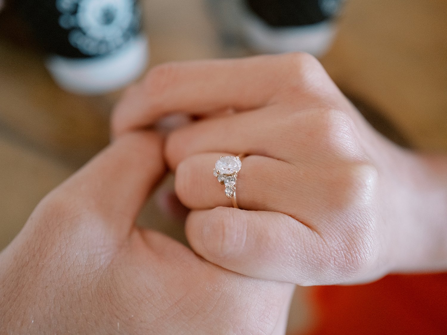 engaged couple holds hands on table at coffee shop in Ocean City NJ