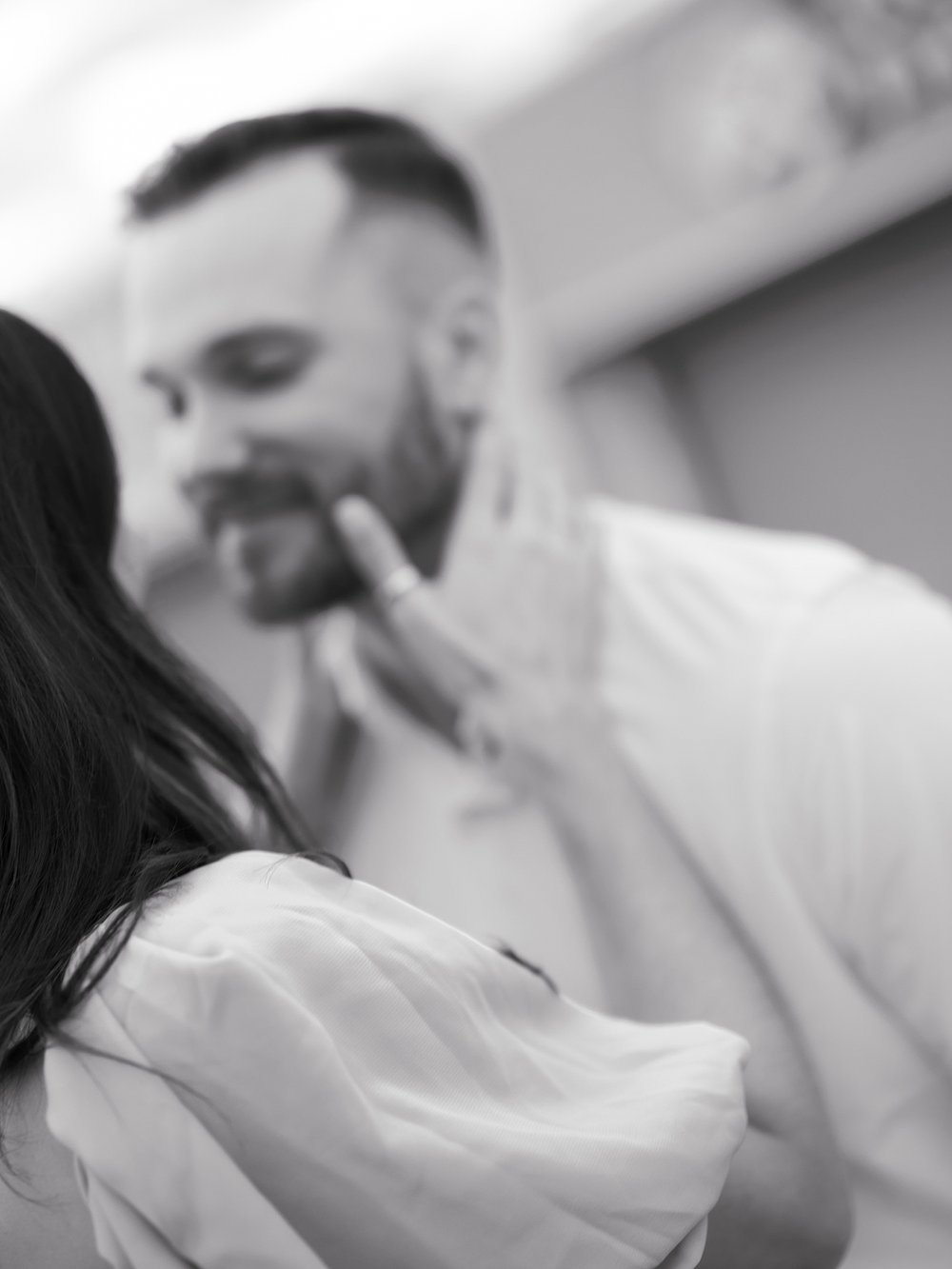 woman holds man's jaw during NJ engagement session