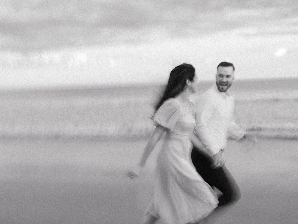 blurry photo of couple running on beach in Ocean City NJ