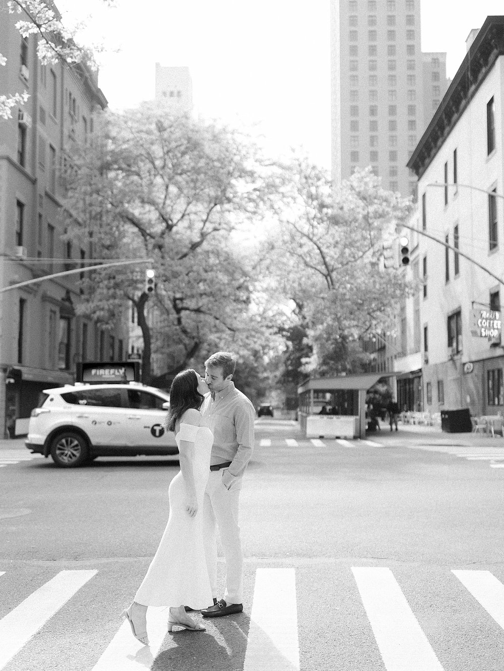 woman turns to kiss man on crosswalk on the Upper East Side in New York City