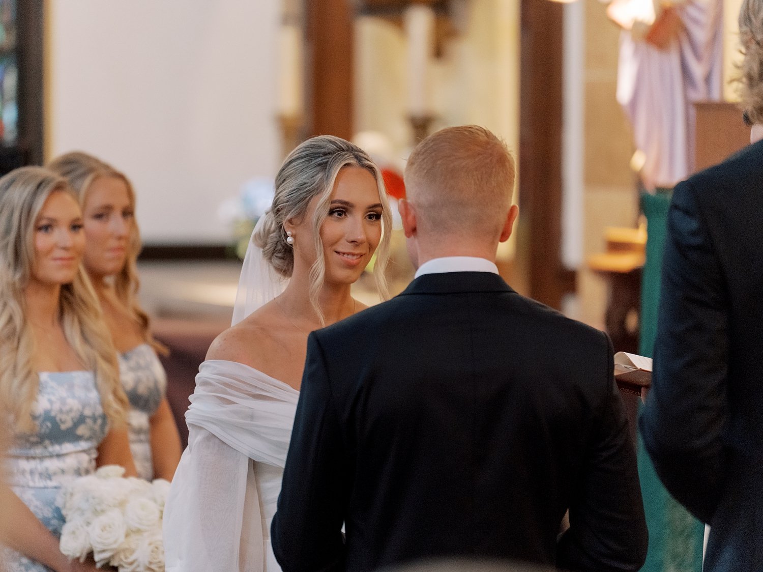 newlyweds exchange vows at alter during traditional church wedding on Long Island