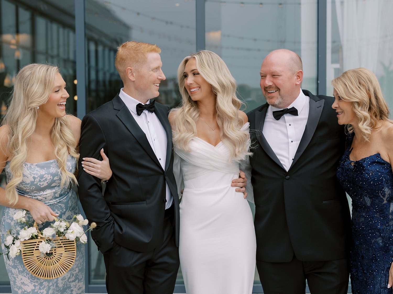 bride and groom hug family outside the Rockaway Hotel