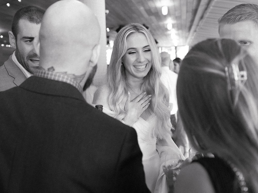 bride laughs talking with guests at the Rockaway Hotel