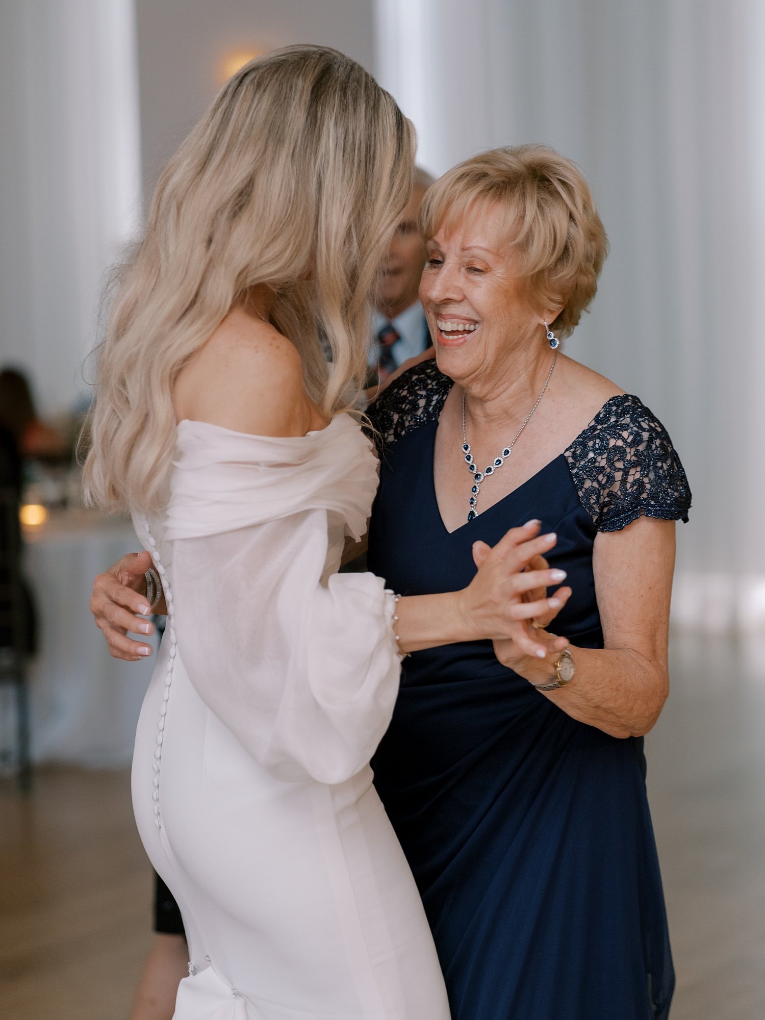 bride dances with mom during Long Island beach wedding reception