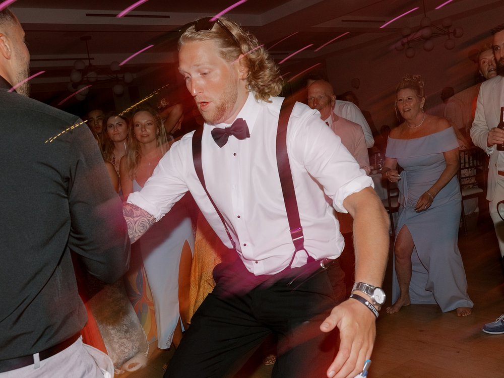 groomsman dances during Long Island beach wedding reception