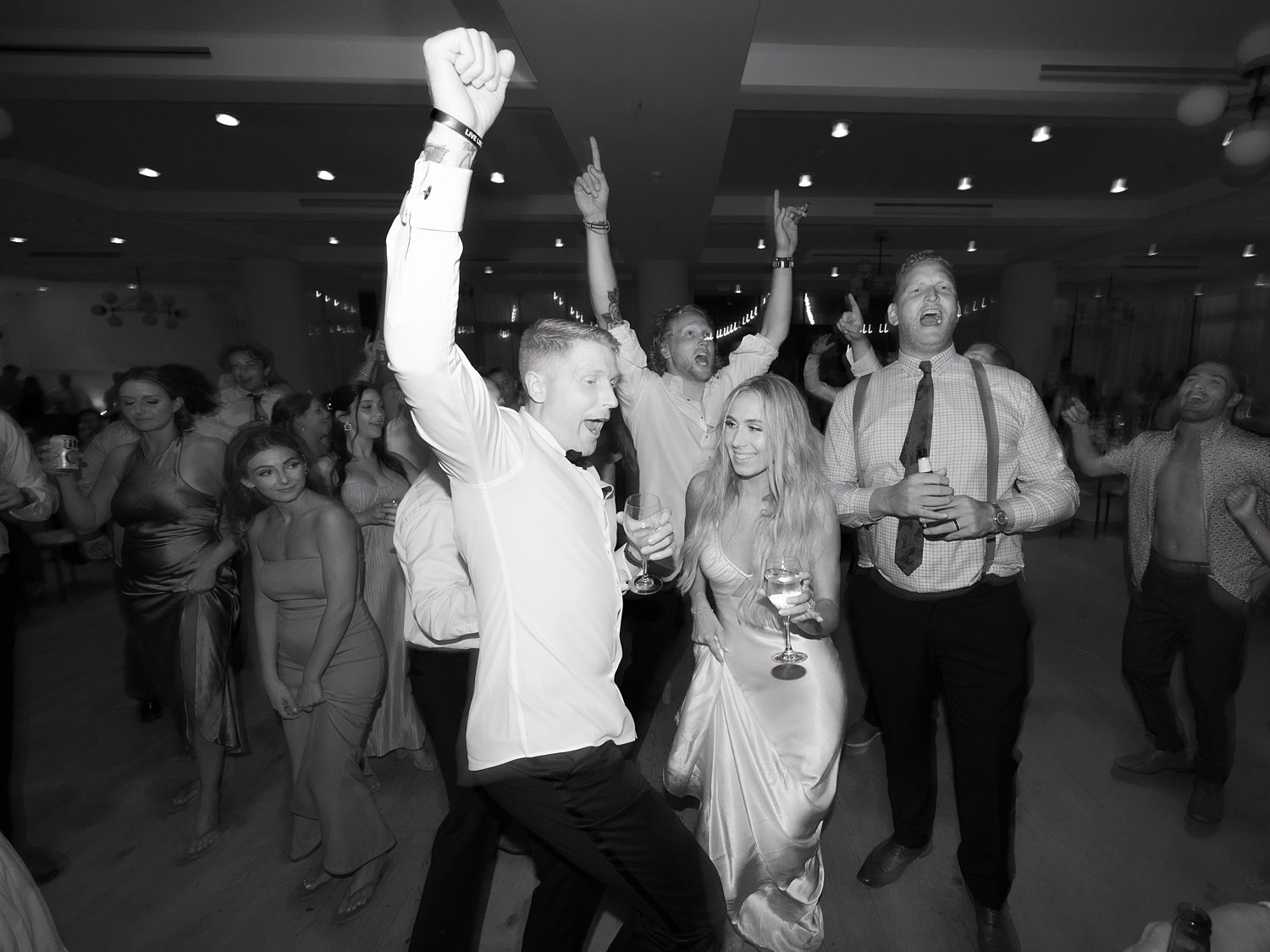 bride and groom dance with wedding party during Long Island beach wedding reception