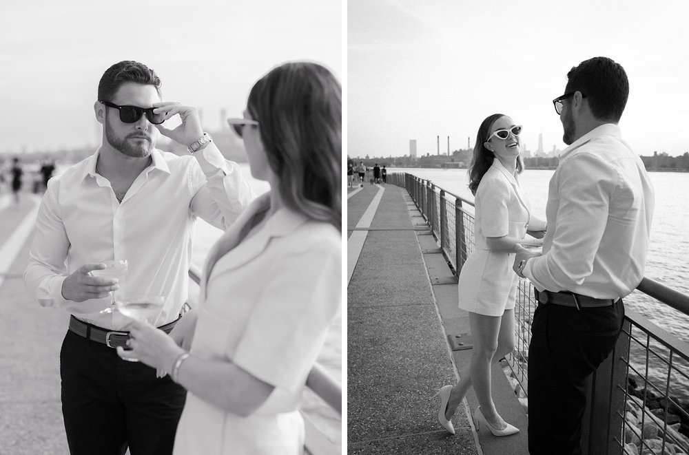 engaged couple laughs drinking champagne in Greenpoint Waterfront Park