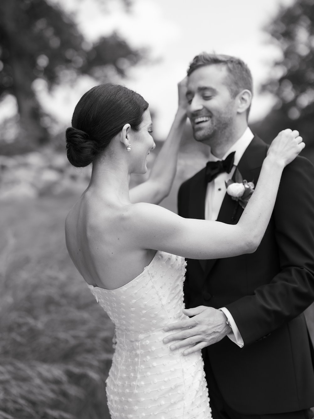 bride leans to hug groom around neck during CT wedding photos