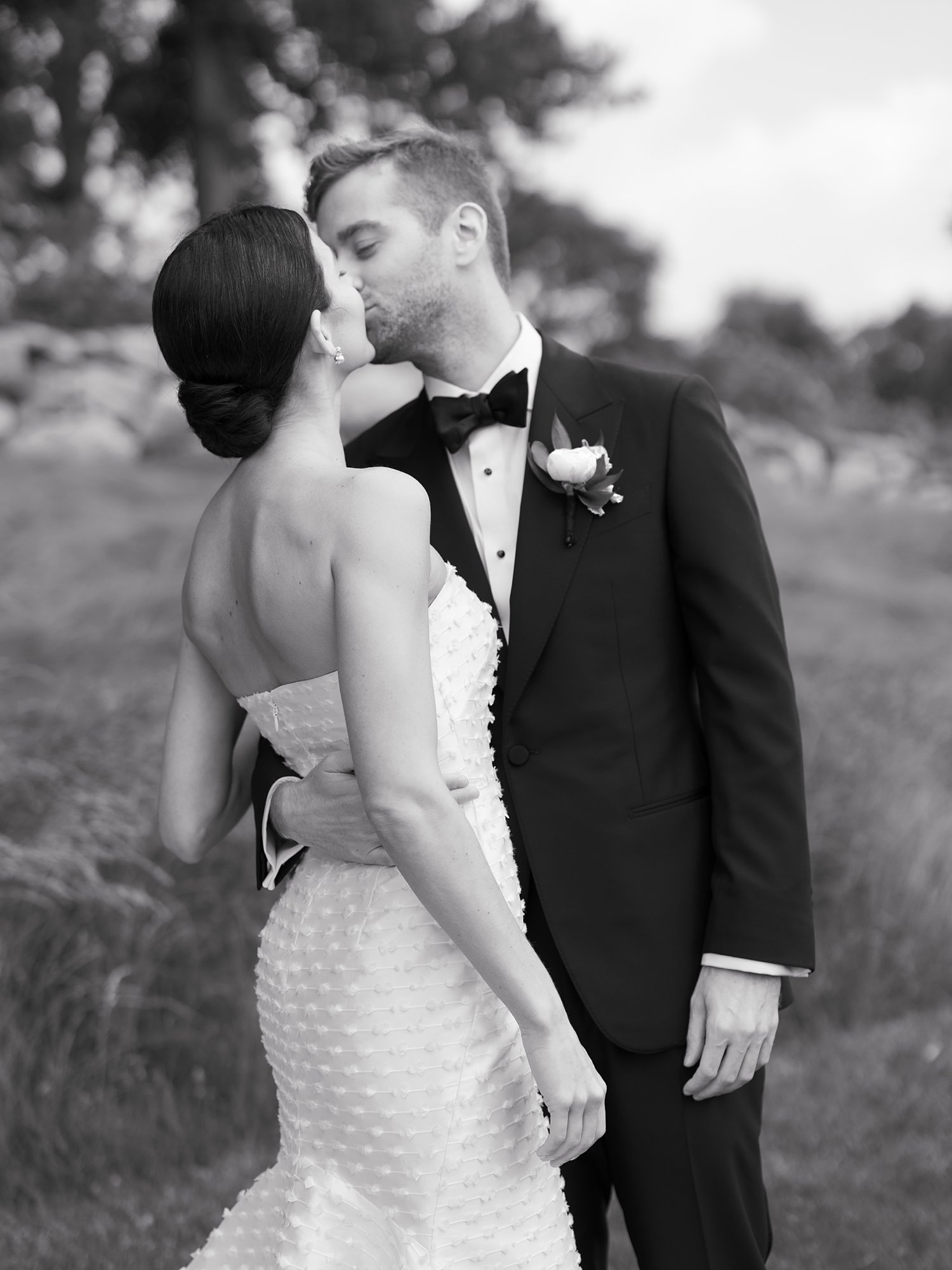 black and white photo of bride and groom kissing at The Country Club of New Canaan