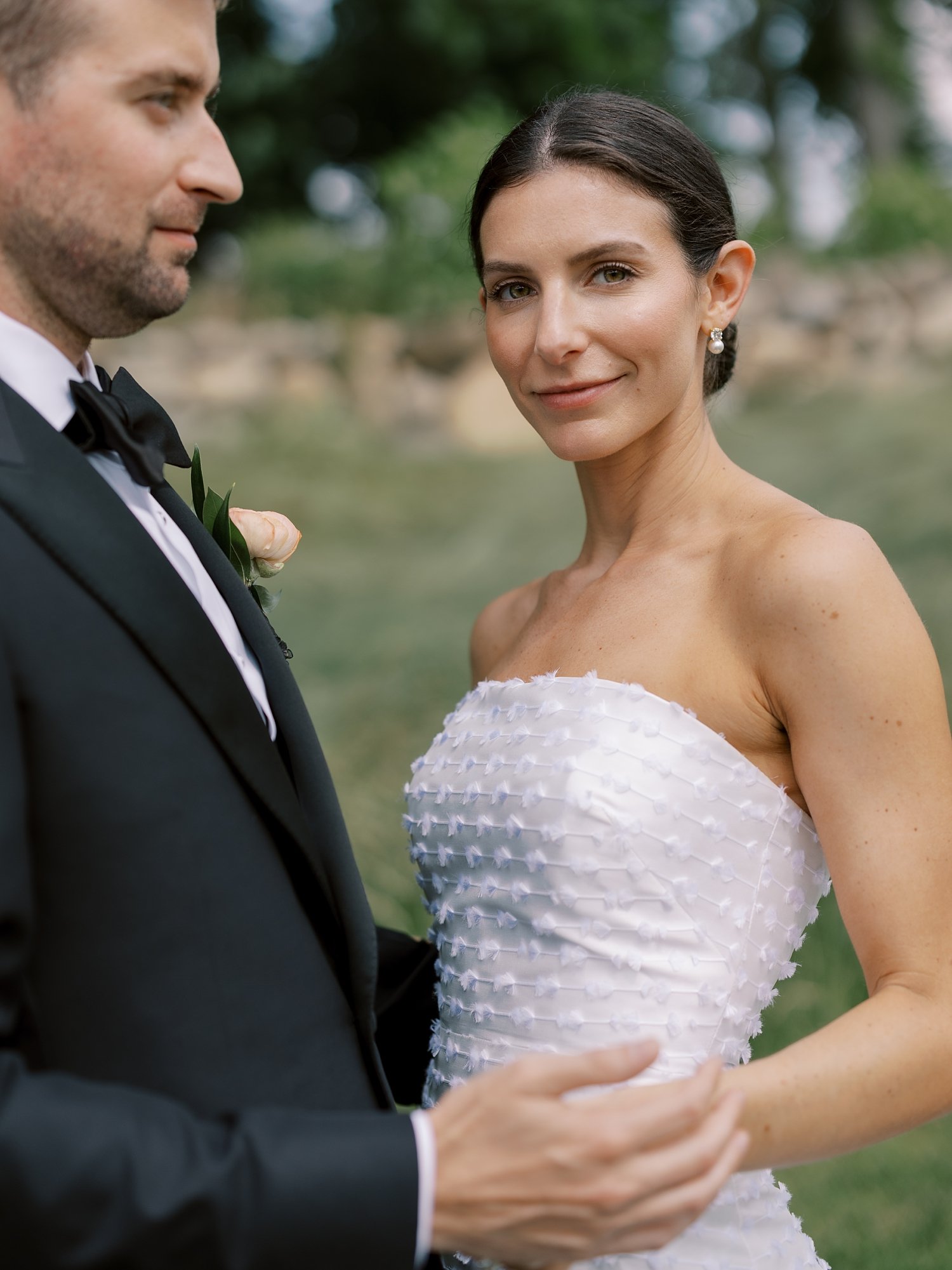 groom reaches to hold bride's hips during portraits at The Country Club of New Canaan