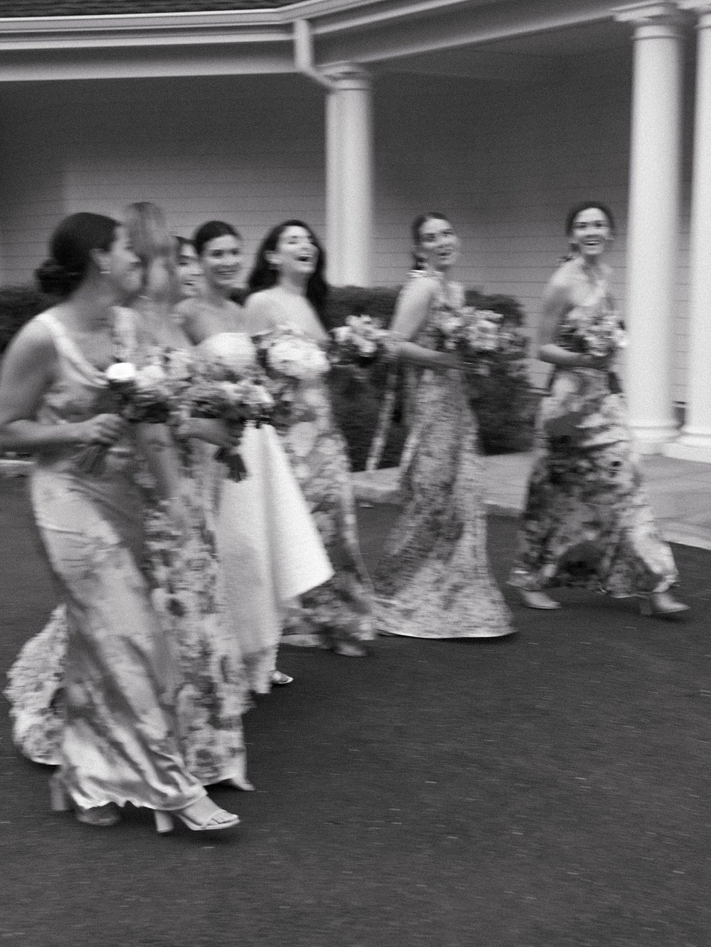 black and white blurry photo of bride and bridesmaids walking